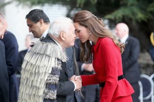 Kate in Christchurch in a red Luisa Spagnoli suit cinched in at the waist by a black belt.jpg
